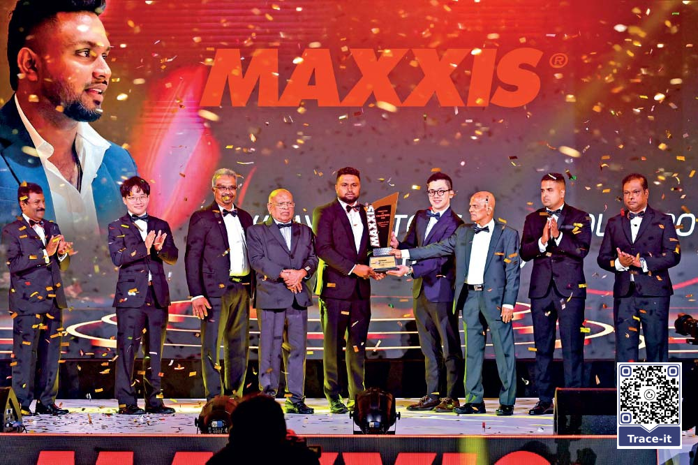 Sajith Sankalana receives the Winner of the Year 2025 trophy at the MAXXIS Champions of Champions awards night in Colombo